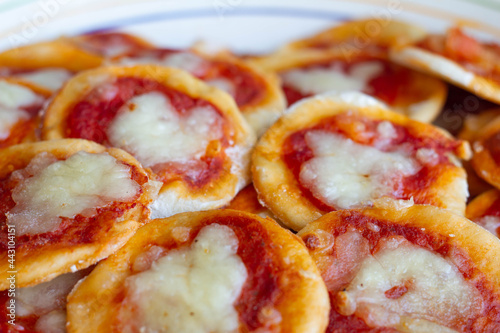 Homemade Pizzette ( Mini Pizza ) a Classic Italian Recipe for Aperitivo  with Mozzarella and tomatoes sauce .Italian style .Traditions food. Italy. photo