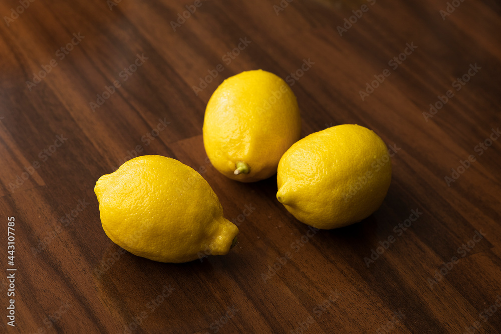 fresh lemons on the dark wooden table
