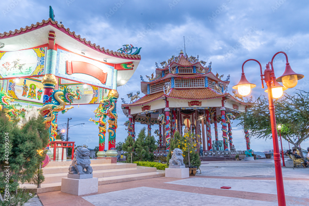 Atmosphere Chao Mae Kuan Yin Shrine, a shrine with people walking in the Koh Loi Park seaside on June 24, 2021, at 06:08 p.m.  at Koh Loi Park, Sriracha District. Chonburi Province, Thailand