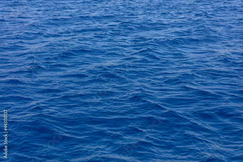 Deep blue ocean surface. Rippled sea water background texture,
