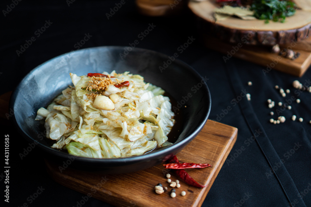 Stir-Fried Cabbage with Fish Sauce on wooden board - Asian food style Stir-Fried Cabbage with Fish Sauce on wooden board - Asian food style