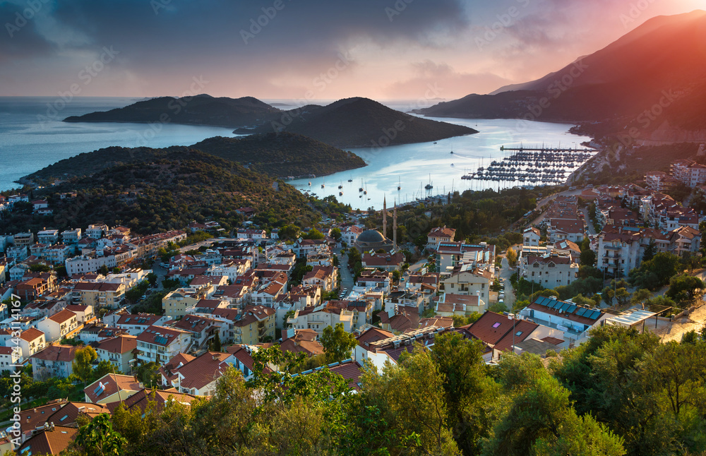 Naklejka premium Amazing panoramic view of resort town Kas and turquoise coast area at sunset. Kas is small fishing, diving, yachting and tourist town. Antalya.Turkey.