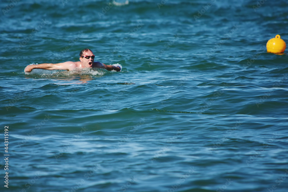 a man swims in the sea, Activities on the water