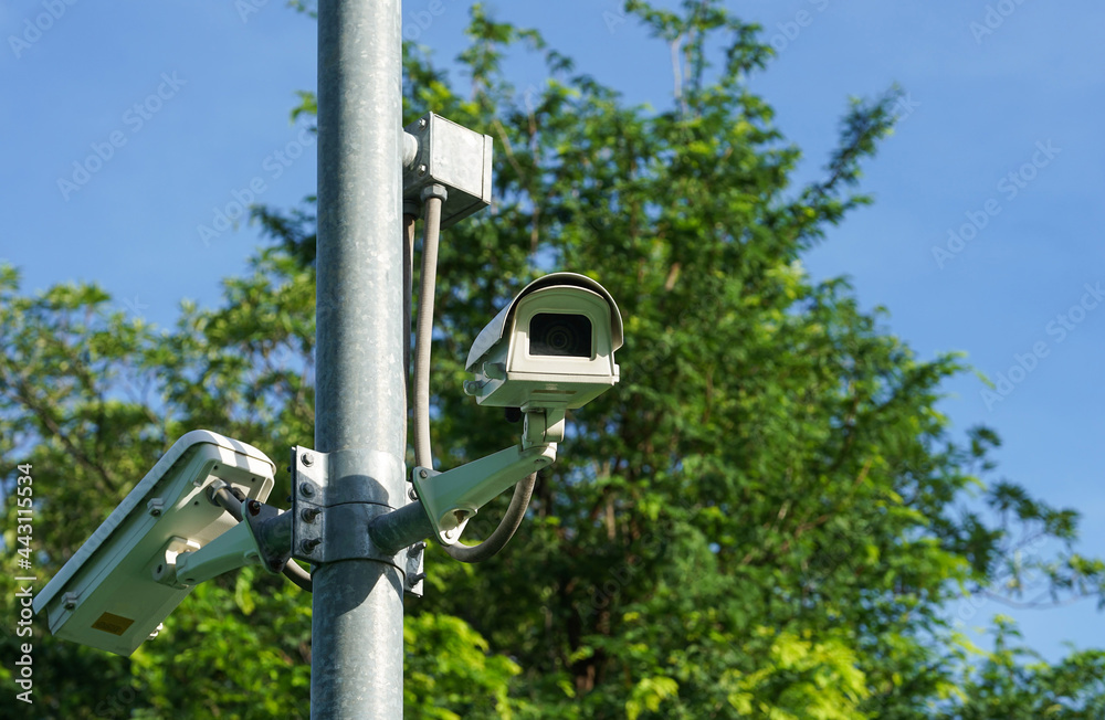 CCTV surveillance camera on pole in the park CCTV surveillance camera on pole in the park