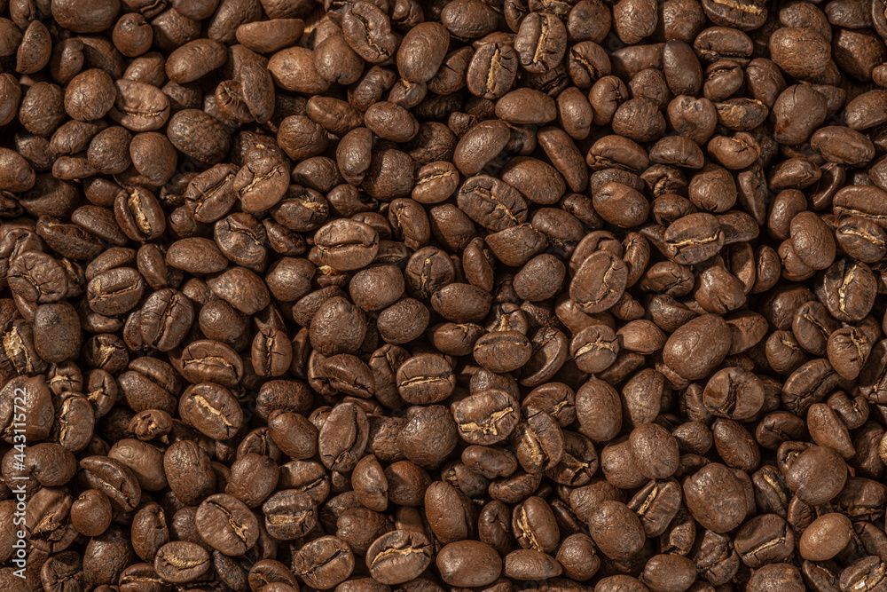Roasted coffee beans closeup Background, Coffee grains scattered on the table, with copy space for your text. Roasted coffee beans closeup Background, Coffee grains scattered on the table, with copy space for your text.