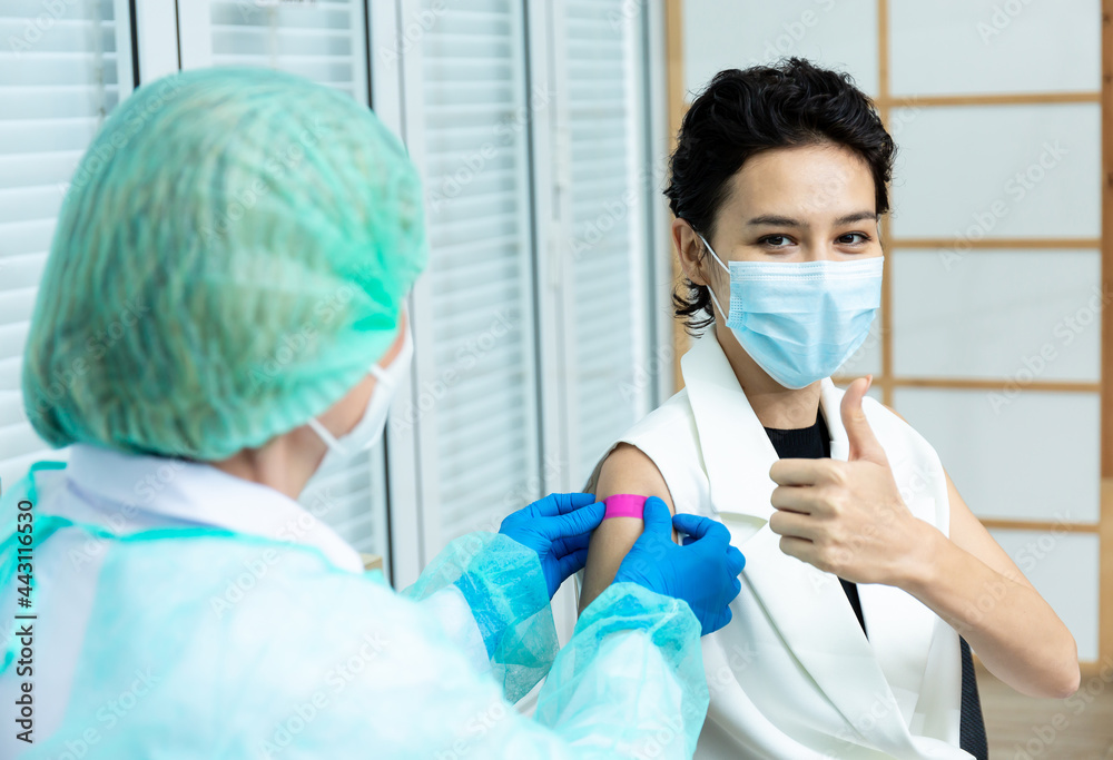woman wearing mask getting vaccinated concept of coronavirus vaccination mask grown woman approved for covid-19 vaccination at the hospital. Female doctor immunizes against virus with medical plaster. woman wearing mask getting vaccinated concept of coronavirus vaccination mask grown woman approved for covid-19 vaccination at the hospital. Female doctor immunizes against virus with medical plaster.