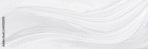 White gray satin texture that is white silver fabric silk panorama background with beautiful soft blur pattern natural. © Kamjana