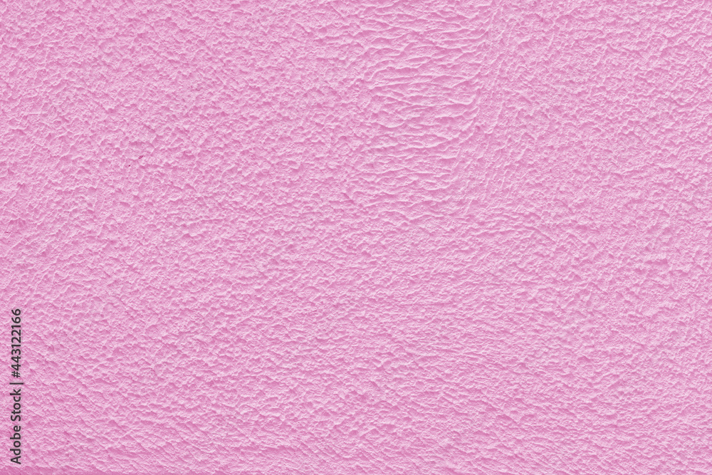 Pink plaster wall of a building. Rough surface texture. Pink plaster wall of a building. Rough surface texture.