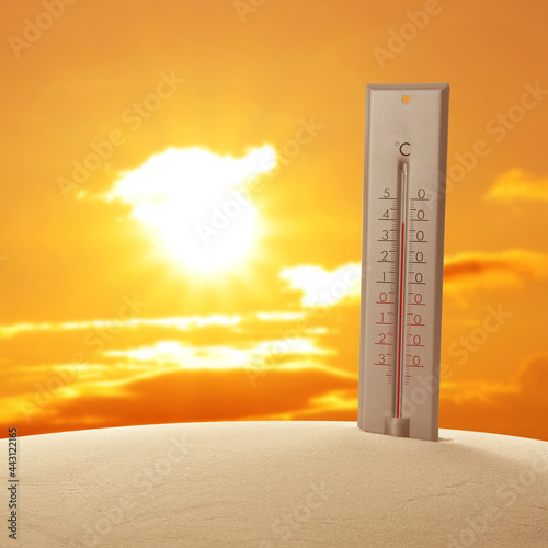 Weather thermometer with high temperature outdoors on hot sunny day. Heat stroke warning
