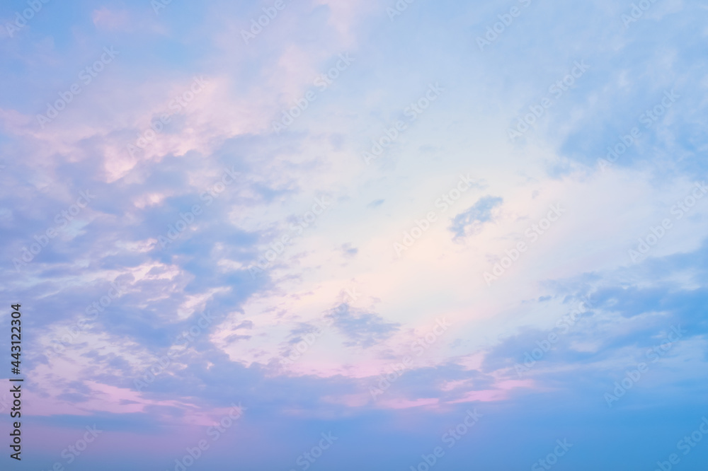 Blue clear sky with magenta gleams of the setting sun at sunset. The texture of the pink sky a minute before sunset.