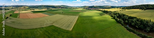 The landscape of the Werra Valley with the Werra River and agriculture fields at Herleshausen in Hesse and Thuringia