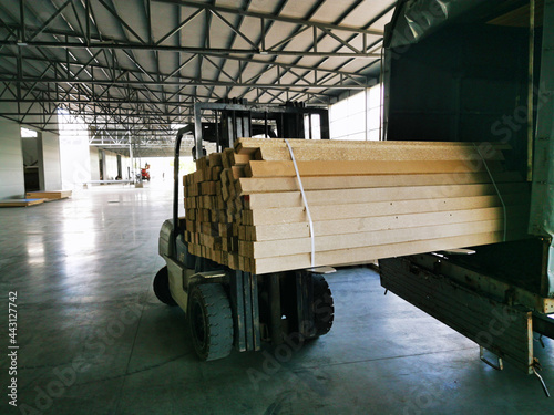 Russia Krasnodar Krai Krasnodar 14.06.2021. Forklift loader pallet Building materials warehouse, logistics concept, construction of houses, loader. Chipboard rows photo