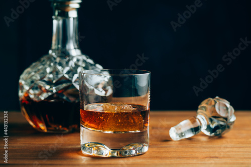 Glass of whiskey near decanter photo