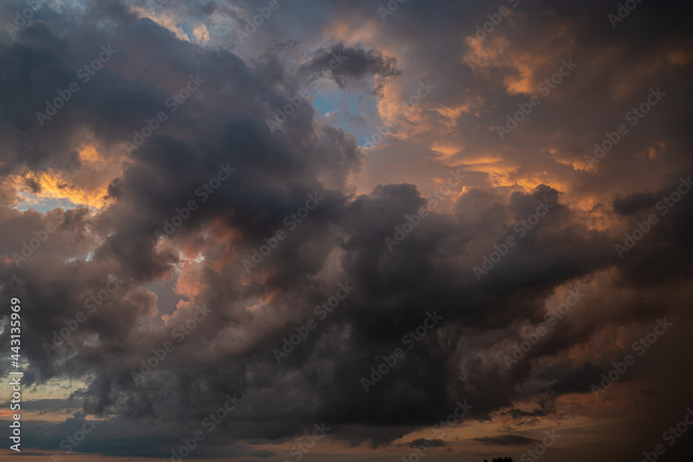 Fototapeta premium a dark thundercloud on the background of sunset