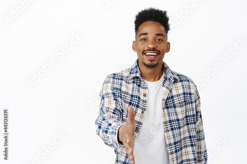 Nice to meet you. Friendly smiling african american man extend hand for handshake, greeting, saying hello, attend meeting and welcome someone, white background