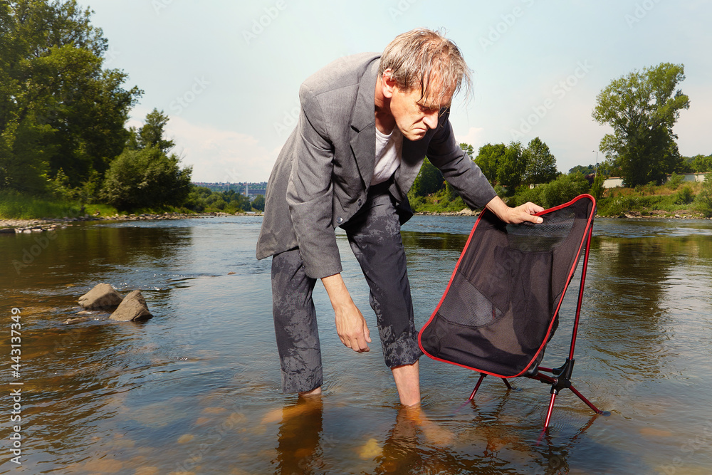 Manager in grey suit became crazy of hot weather and cooling in river Manager in grey suit became crazy of hot weather and cooling in river