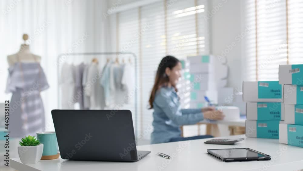 Digital tablet computer or laptop on home office desk with asia freelance seller woman happy packing check busy work in fashion studio SME online store social e-commerce sale page service web support. Digital tablet computer or laptop on home office desk with asia freelance seller woman happy packing check busy work in fashion studio SME online store social e-commerce sale page service web support.