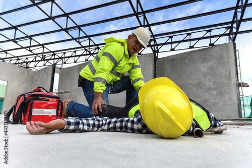 Accident at work of construction worker at site. Builder accident falls scaffolding on floor, First aid team rushed in to take care prepare helps employee accident. Safety in work concept. photo