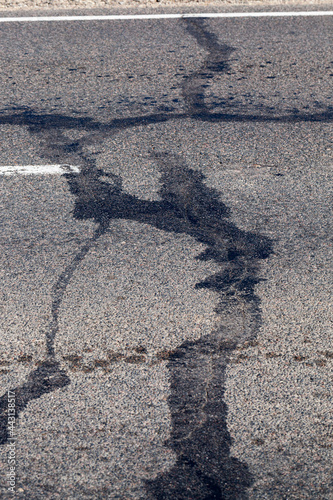 part of an asphalt road with damage