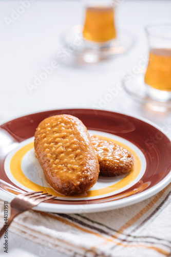 Bosnian and Turkish dessert called Hurmasica served on a grey background with cup of coffee photo