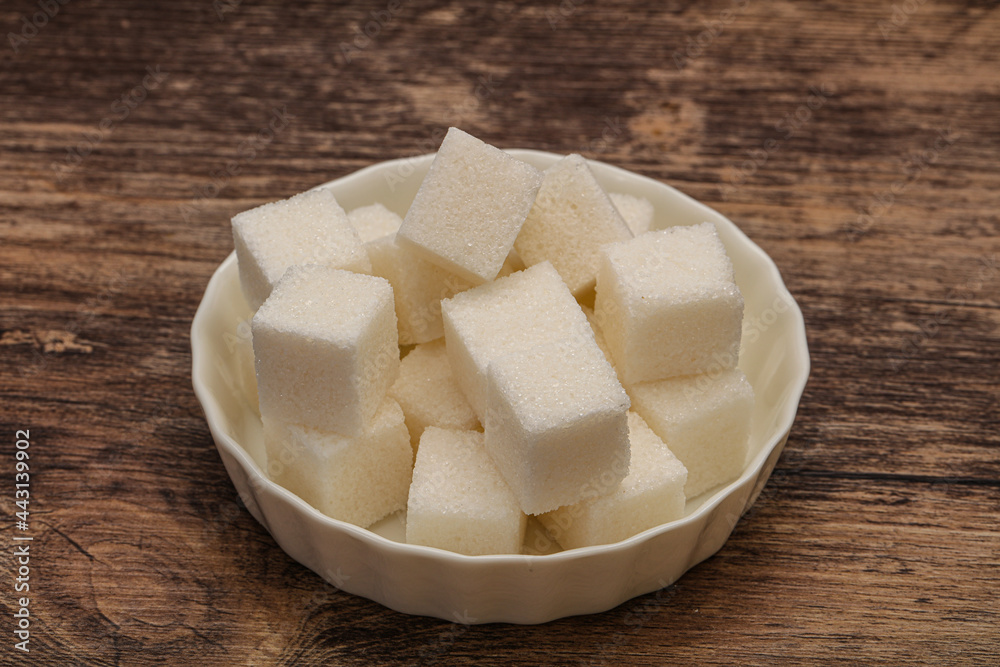 Refined white sugar cubs in the bowl Refined white sugar cubs in the bowl