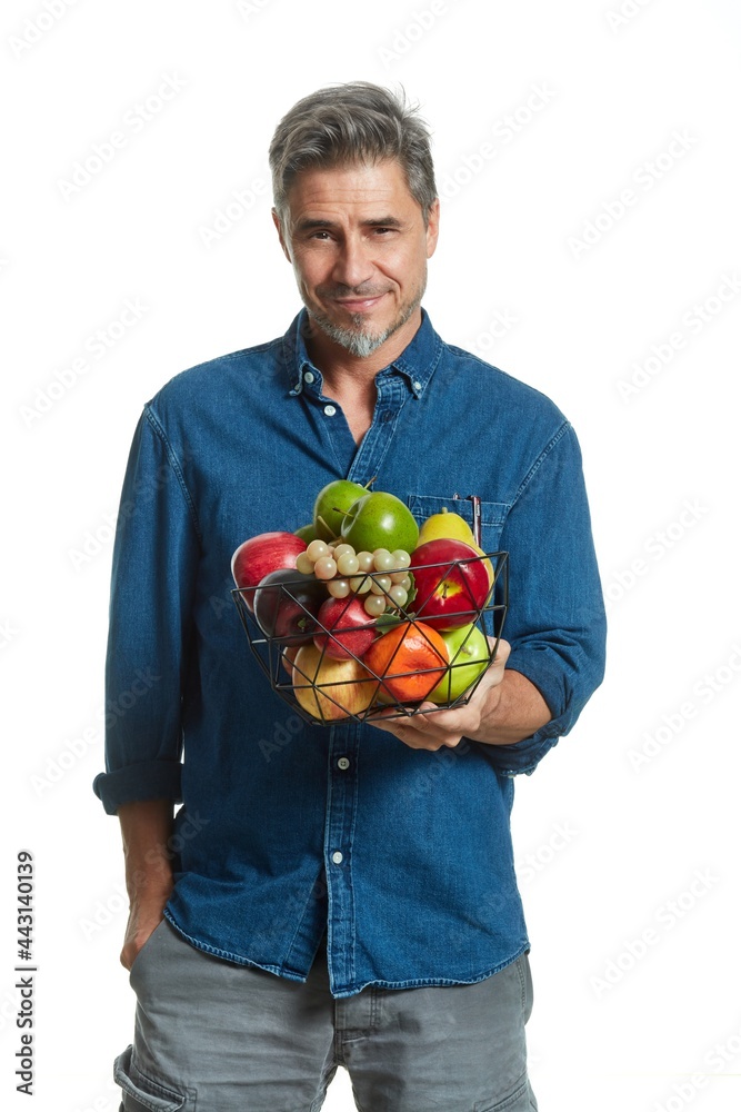Casual older white man man holding basket of fruits - healthy eating. Casual older white man man holding basket of fruits - healthy eating.