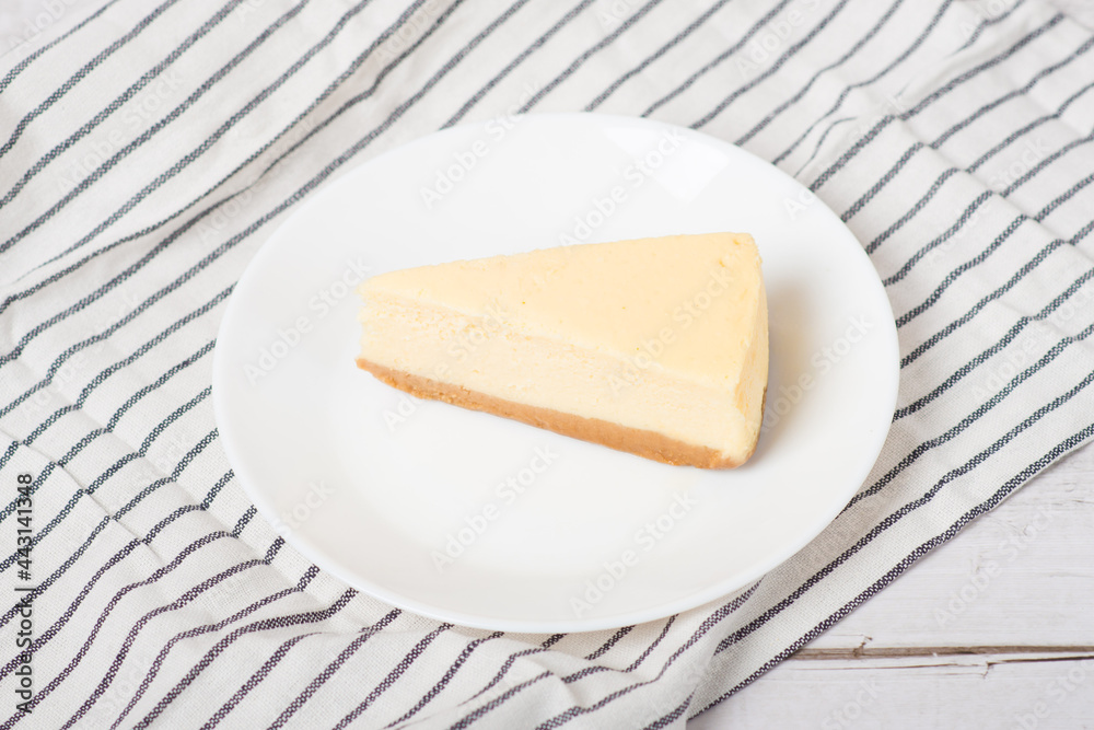 classic cheesecake on a white wooden table.