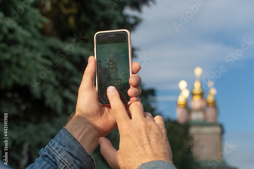 Adult tourist taking photo – Sergiev Posad, Russia. Greatest Russian monastery of Golden Ring. Summertime wanderlust concept scene.