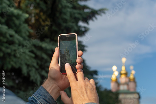 Adult tourist taking photo – Sergiev Posad, Russia. Greatest Russian monastery of Golden Ring. Summertime wanderlust concept scene.