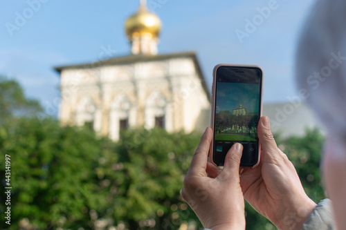 Adult tourist taking photo – Sergiev Posad, Russia. Greatest Russian monastery of Golden Ring. Summertime wanderlust concept scene.
