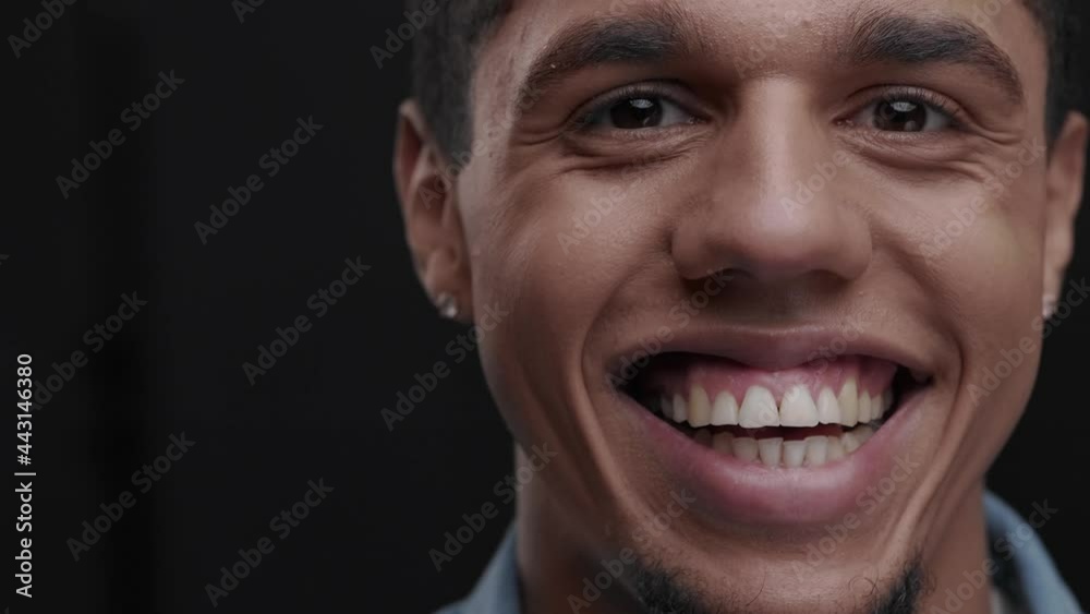 Black man staring at camera. Close up face of young African American handsome man with beard looking at camera and smiling joyfully. Portrait of good-looking happy guy with smile indoor. Black man staring at camera. Close up face of young African American handsome man with beard looking at camera and smiling joyfully. Portrait of good-looking happy guy with smile indoor.