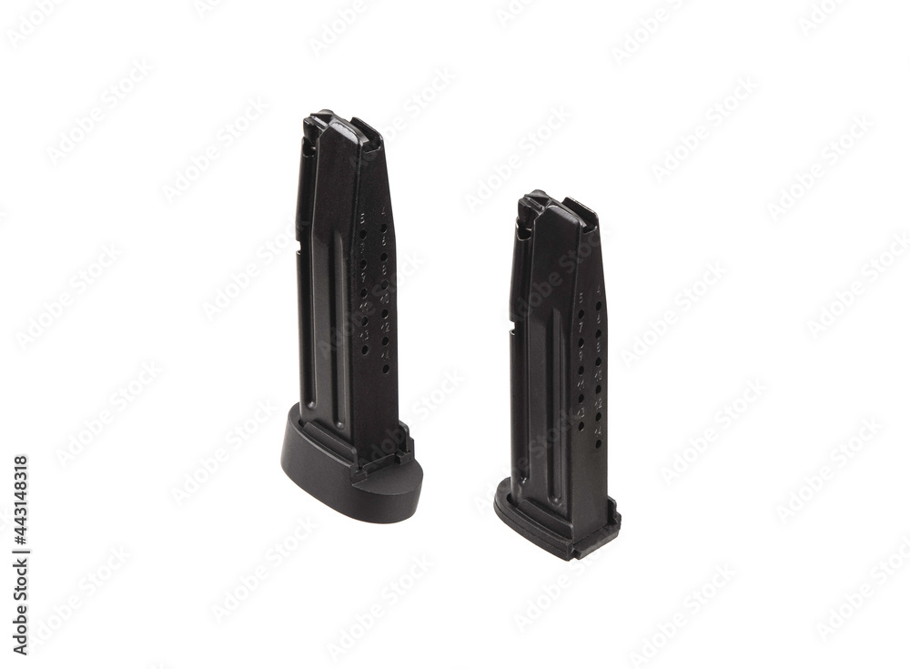 Handgun magazine on white surface. Weapon clips. Isolate on a white back Handgun magazine on white surface. Weapon clips. Isolate on a white back