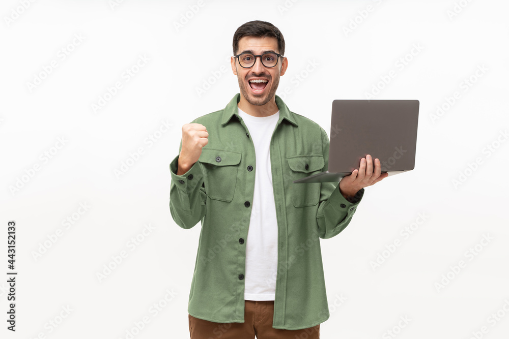 Screaming amazed winner holding laptop and celebrating success, isolated on gray background Screaming amazed winner holding laptop and celebrating success, isolated on gray background