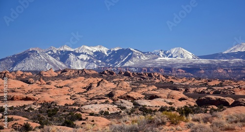 the petrified sand dunes and snow-capped la sal mountain range in arches national park, near moab, utah