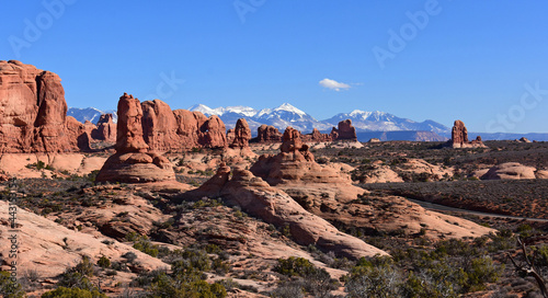 the eroded rock formations of the fiery furnace against a backdrop of the snowy la sal mountains in arches national park, near moab, utah 