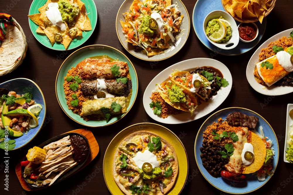 Typical mexican food, tacos, tamales, guacamole, tostadas, fajitas, top view on wooden background