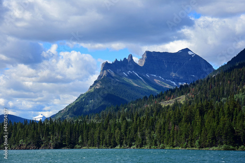 the spectacular peaks,  lake,  and forests  of glacier national park, as seen from the  boat ride to  goat haunt, montana
