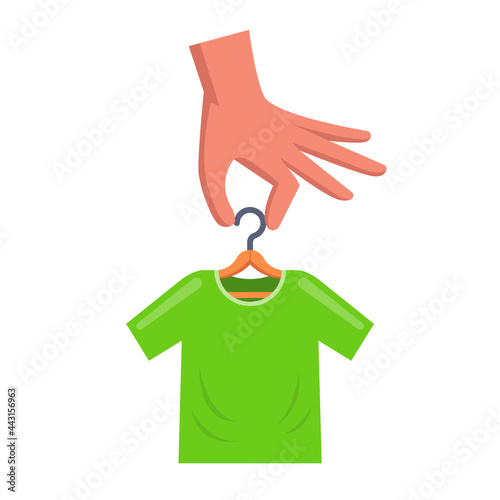 man is holding a hanger with a green t-shirt. flat vector illustration.