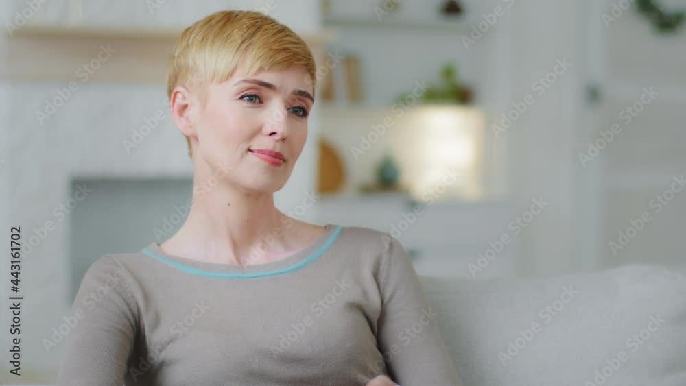 Single idler woman enjoy lazy weekends resting lean on comfy couch relaxing in living room, holding remote control switch channels watch TV spend time at home. Streaming digital television ad concept Single idler woman enjoy lazy weekends resting lean on comfy couch relaxing in living room, holding remote control switch channels watch TV spend time at home. Streaming digital television ad concept