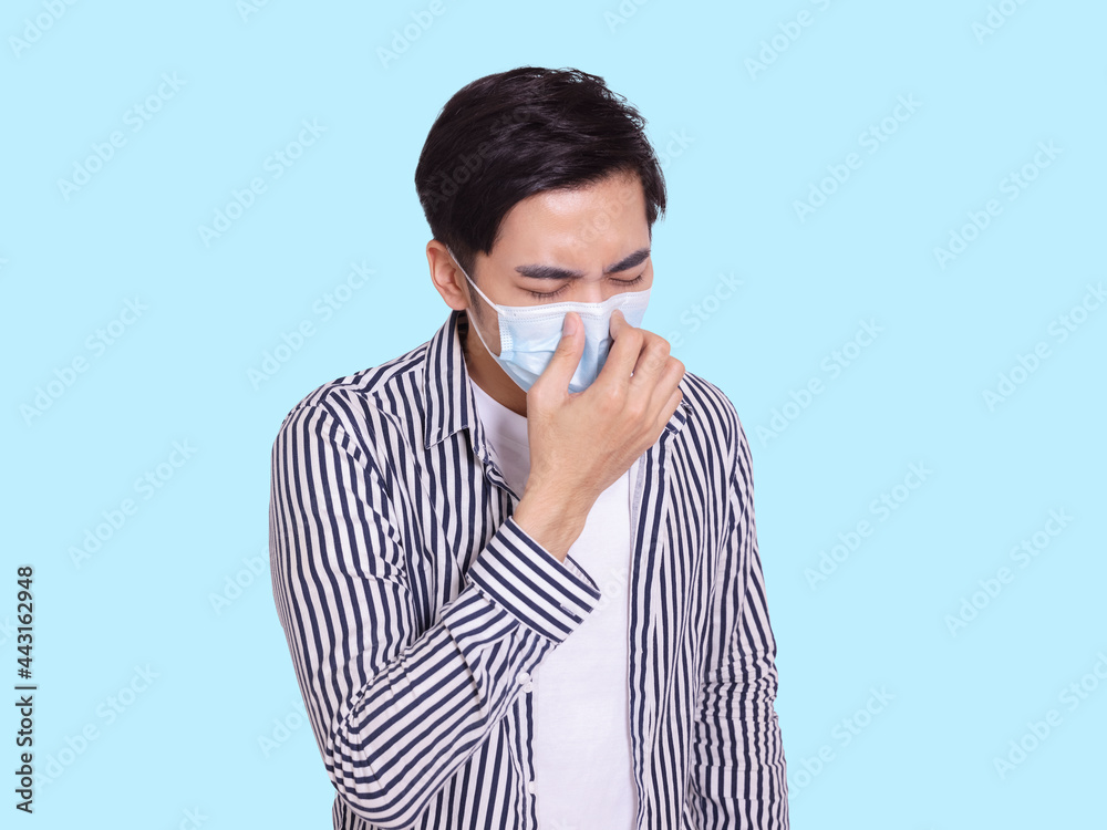 young man wearing protective medical mask, pinched his nose and sneezed young man wearing protective medical mask, pinched his nose and sneezed