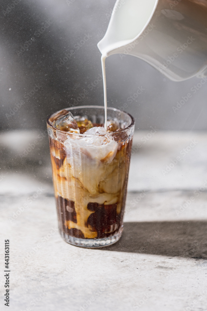 Coffee with cream art. Pouring cream into coffee Coffee with cream art. Pouring cream into coffee