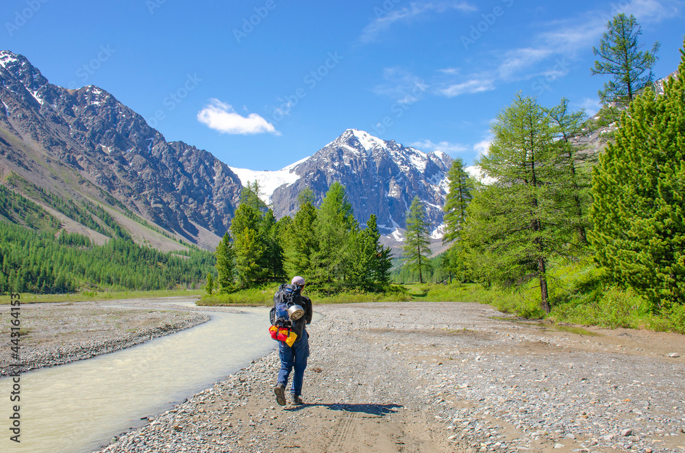 Tourist man goes to mountains glacier Aktru Russia
