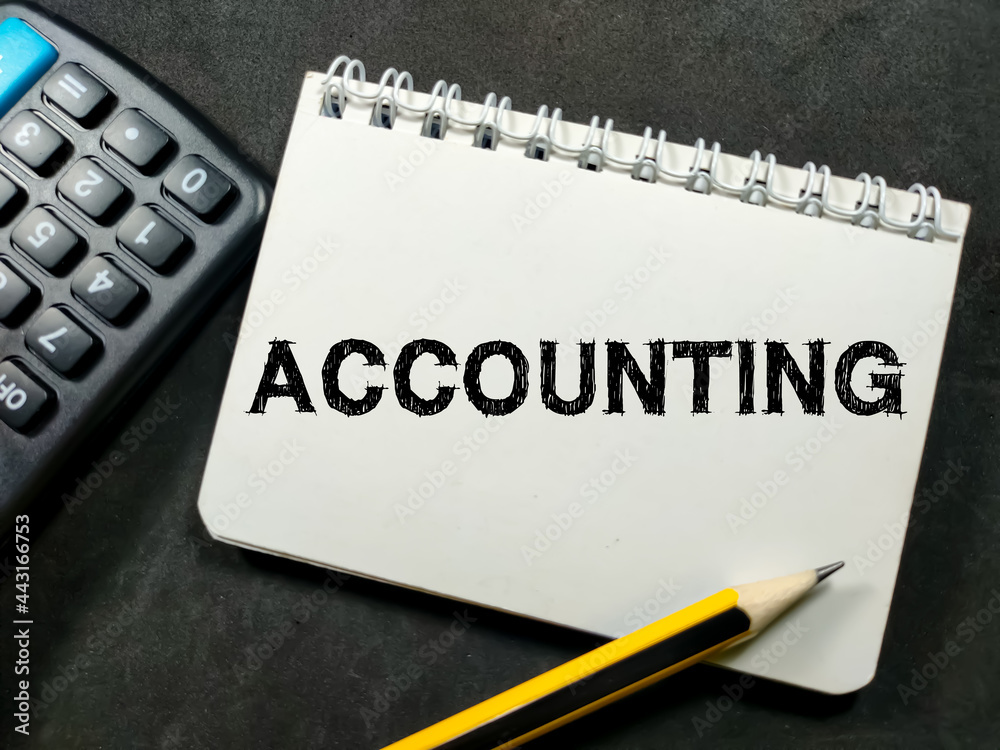 Business concept.Text ACCOUNTING on notebook with pencil and calculator on black background.