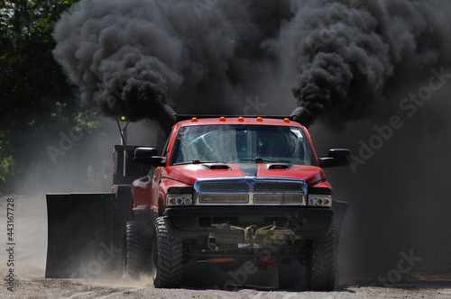 red truck at a tractor pull meeting billowing black smoke photo