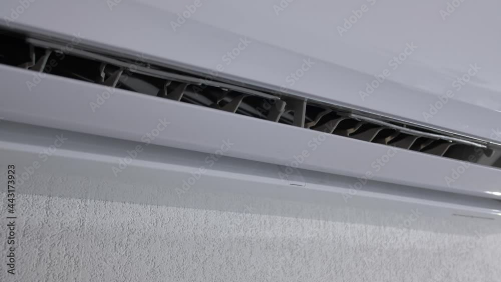 The activation of air conditioner, close up view. Start and end work of air conditioner. The cooling device is working on the room wall. The activation of air conditioner, close up view. Start and end work of air conditioner. The cooling device is working on the room wall.
