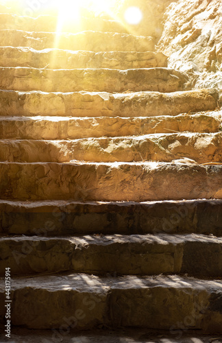 ancient steps on the stairs at the National Museum in Israel. Sunlight shines from above the frame