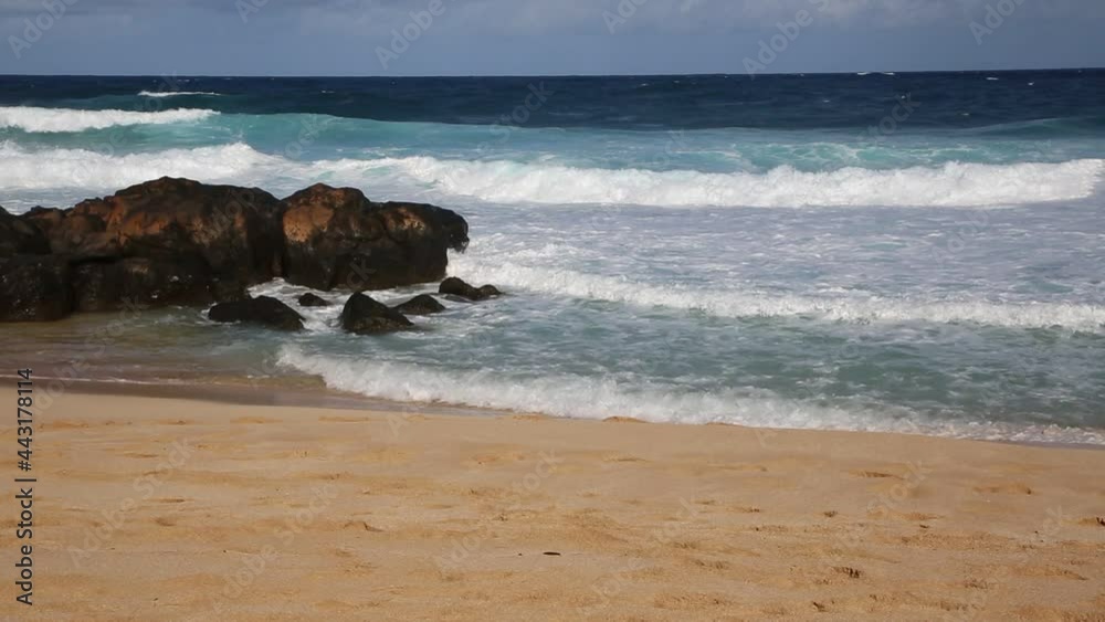 Breaking waves and rocks on the beach, Hawaii Breaking waves and rocks on the beach, Hawaii