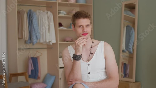 Portrait young smiling transgender transsexual gay man applying make-up looking at camera. LGBTQ Man wearing women's clothing with makeup. womanlike man on face and woman clothes, fashion glamorous photo