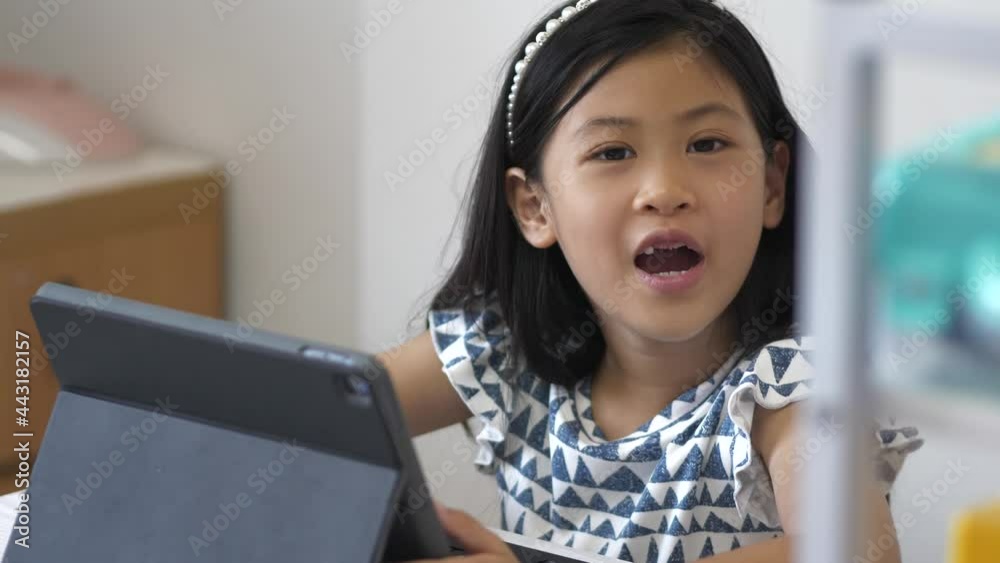 Selective focus of happy kid online studying near laptop at home Selective focus of happy kid online studying near laptop at home