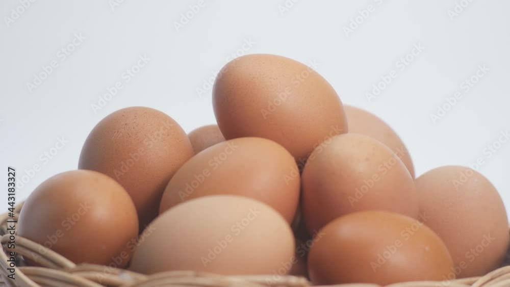 Closeup of Chicken egg rotates on white background. Rotating basket With Brown Eggs On Turntable.side view.Slowly Rotating video.Concept Fresh organic food.4K 2160p 30fps UltraHD footage Closeup of Chicken egg rotates on white background. Rotating basket With Brown Eggs On Turntable.side view.Slowly Rotating video.Concept Fresh organic food.4K 2160p 30fps UltraHD footage